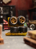 Set of model car tires on a stand in a workshop setting